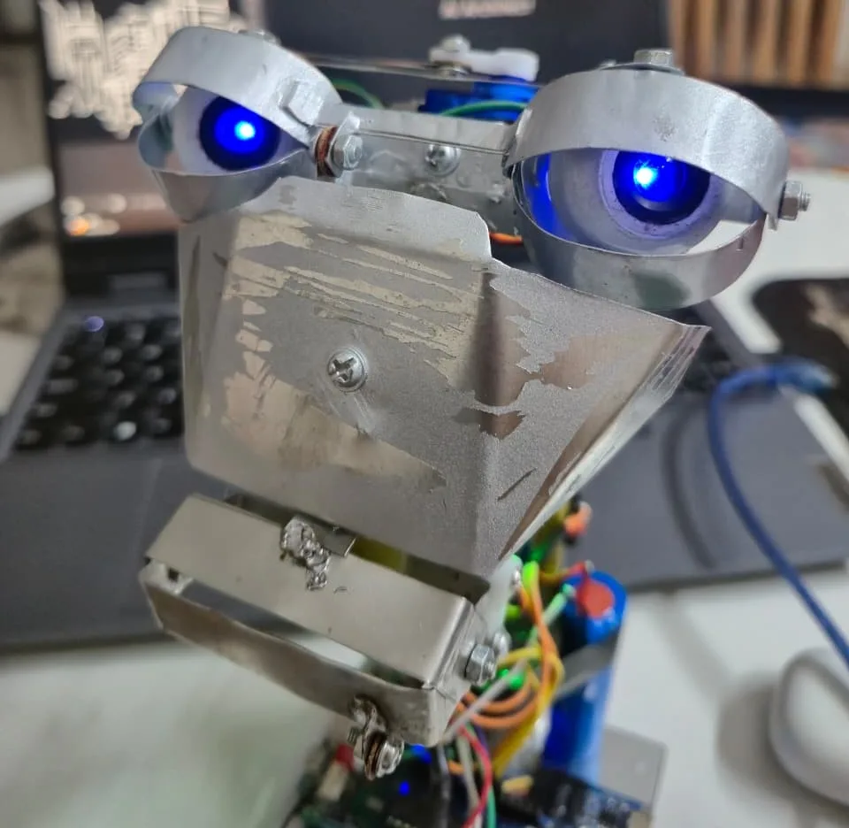 Early assembly of the robot head showing the servo layout and wiring